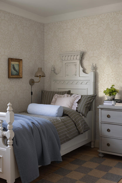 The light, large-floral wallpaper Hildasholm is adorned with a dense Arts and Crafts-inspired pattern made up of peonies, cornflowers, lily of the valley and other local plants from the gardens around Hildasholm manor house in Leksand.