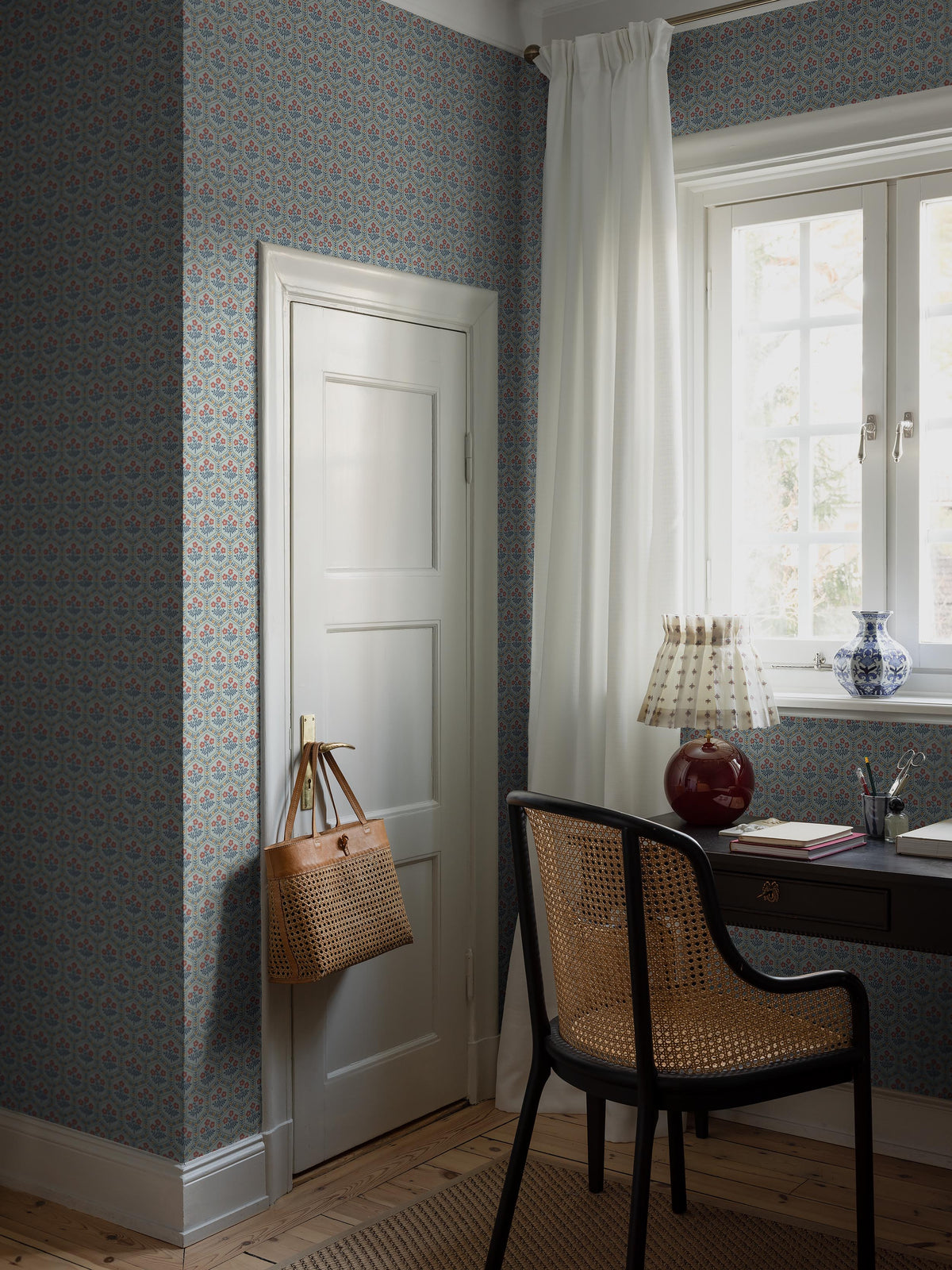 Cecilia is a small-scale floral wallpaper with a rhythmic pattern of sweet little flowers framed by geometric floral garlands.