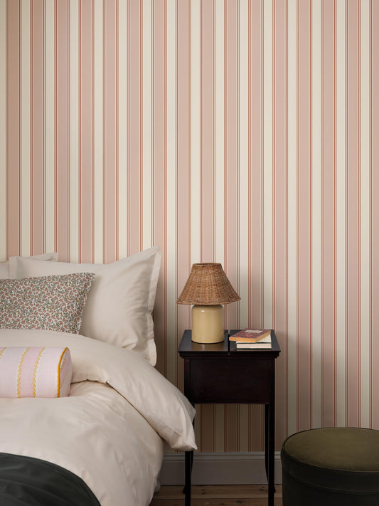  A timeless stripe in a soft, sophisticated color palette adorns the Striped wallpaper Eleonora. 