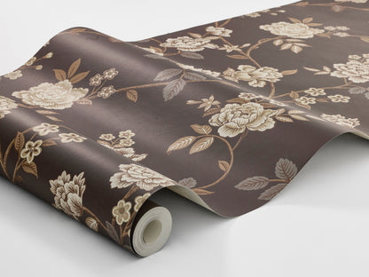 The dark, large-floral wallpaper Peony Garden creates a romantic yet slightly dramatic impression, with its delicate floral vines surface-printed in beige, grey and brown on a warm brown-black background.