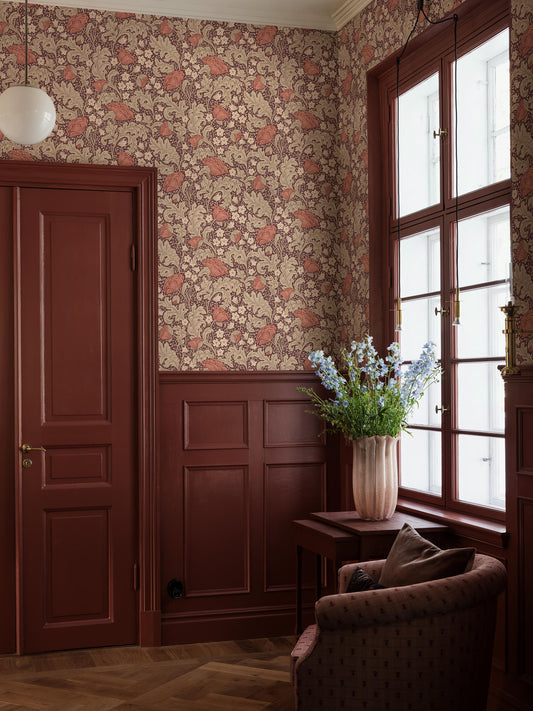 Blomdansen is a large-floral wallpaper with a dense, winding pattern of pale bluebells and lush peony poppies.