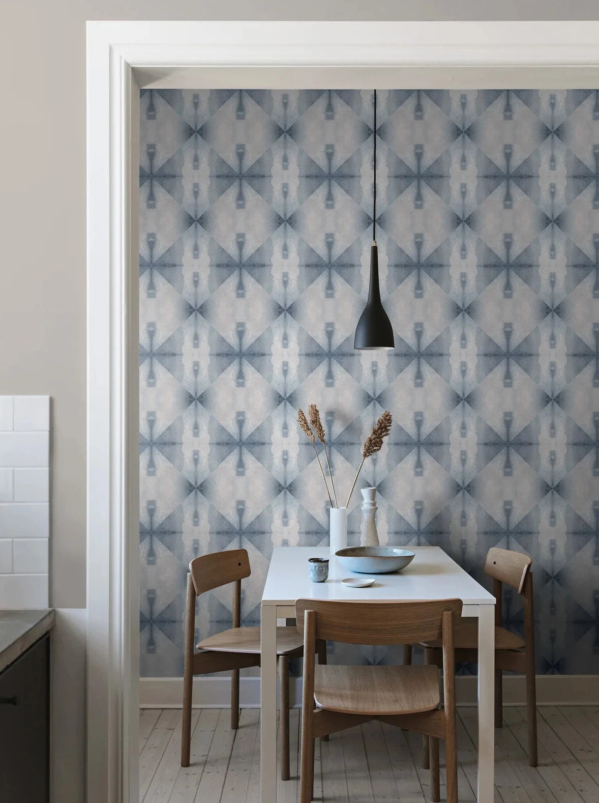 Wallpaper Shibori has a geometric pattern based on folded paper that is then softly colored – in this case in Indigo Blue.