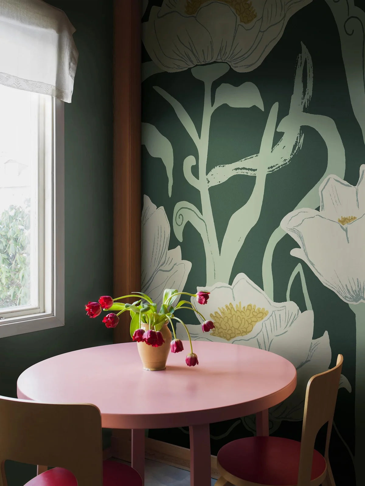 Painted against a backdrop of calming and subdued forest green, Buttercup wallpaper offers a large-scale design with a modern feel. 