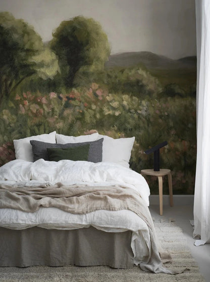 The wallpaper Agnes Meadow is like a giant oil painting where the blooming meadow transitions into green trees and then fades into rolling hills far beneath the bright clouds.