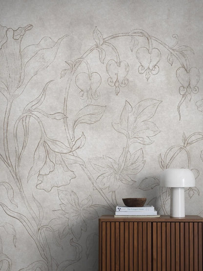 The light gray-beige wallpaper Burning Heart is adorned with delicate bleeding hearts and bellflowers on a discreetly marbled background. 