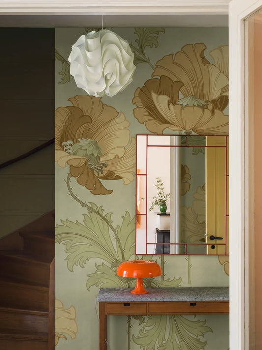 This Vallmo mural wallpaper has gentle palette with its sandy yellow and ochre poppy flowers, and green foliage spreading across a light green background.