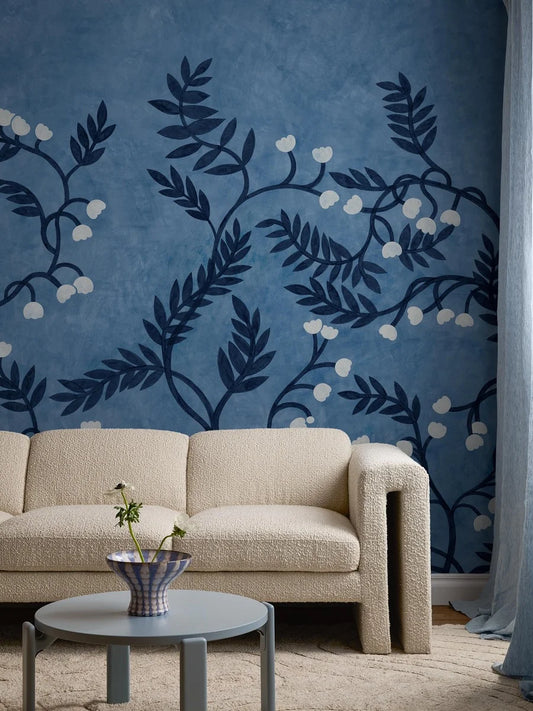 The Whispering Bell mural wallpaper is adorned with a sculptural pattern of stems and leaves, with small delicate flower bells appearing here and there in contrasting colors