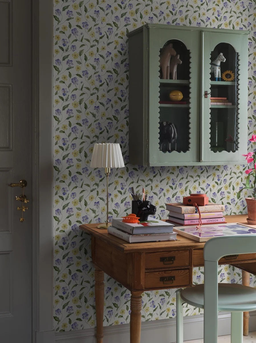  The wallpaper is hand-painted in purple, blue and pale yellow on a light beige background with a paper-like texture, reminiscent of unbleached pressed paper. 