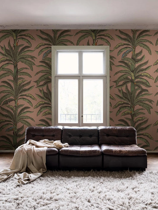 Wallpaper printed custom fit on demand in multiple colorways. Here, green palms stand out against a warm apricot-pink background.