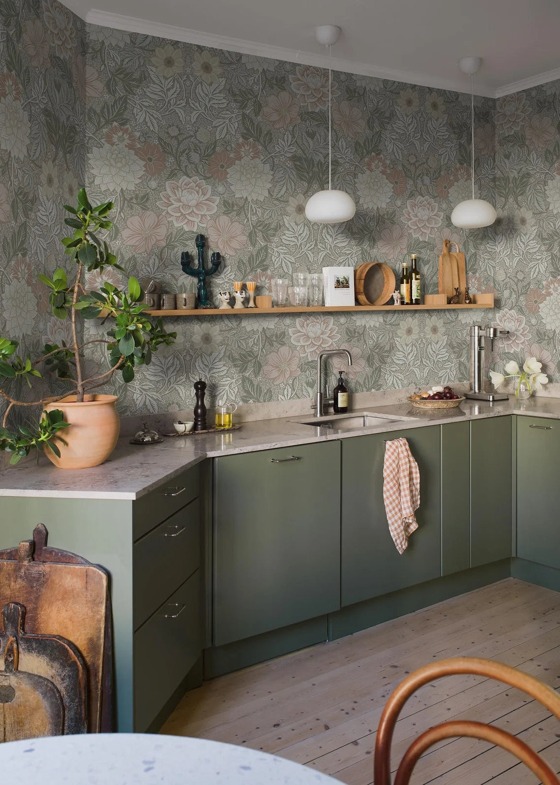 Here, Dahlia Garden Grand wallpaper mural comes in a muted palette of rose red, pale yellow, and gray-green on a beige background.