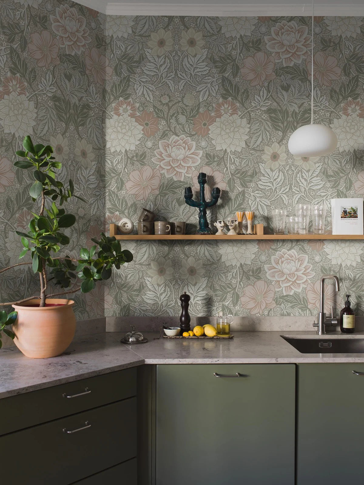 Here, Dahlia Garden Grand wallpaper mural comes in a muted palette of rose red, pale yellow, and gray-green on a beige background.