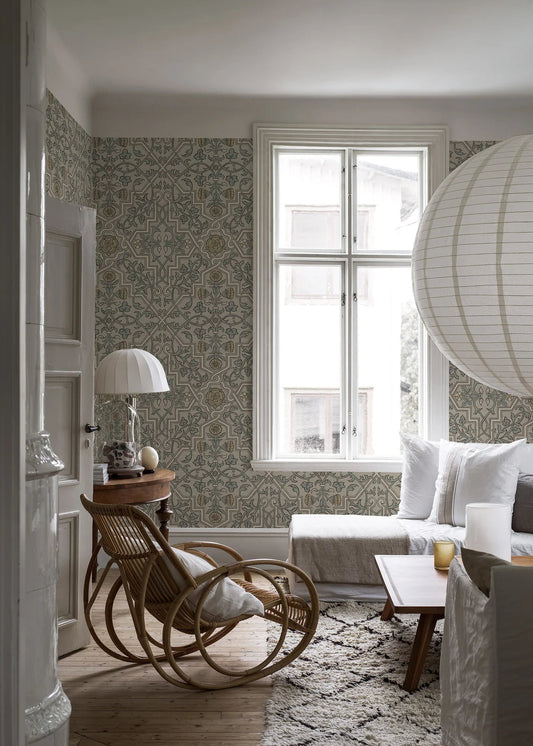 Here, Rosenvinge Grand’s floral ornaments come in a soft, refined palette with blue-green leaves and pale yellow flowers on a beige background.