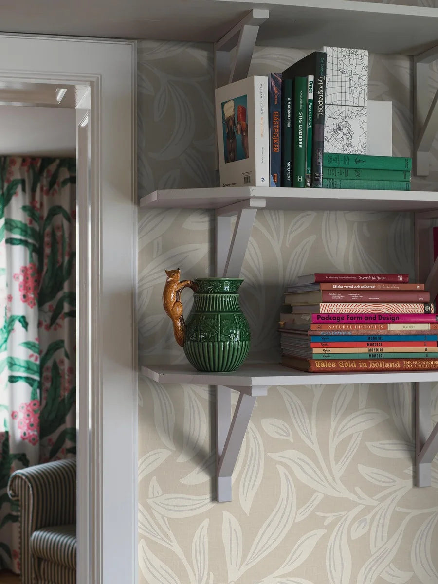The light Vintergröna Grand features a large-scale, winding foliage pattern with clear Arts &amp; Crafts influences. The wallpaper is an enlarged reprint of Vintergröna and is custom fit to your wall.
