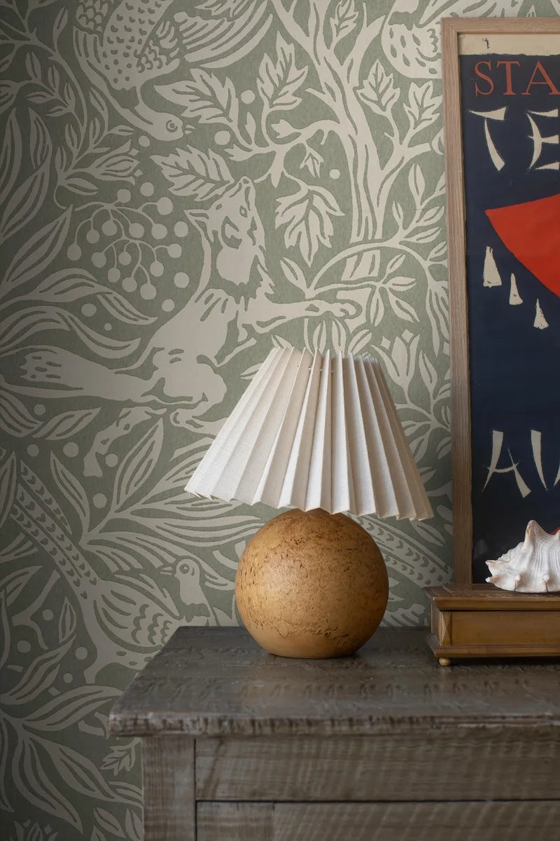  Under the Elder Tree Grand is a boldly patterned wallpaper, covered in lush foliage filled with playful animals. 