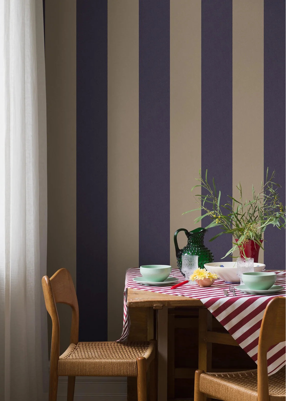 Bjärö Stripe wallpaper comes in linen beige and muted navy blue – an elegant, toned-down color palette that gives the wide stripes a sense of timeless calm.