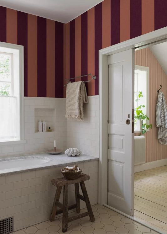 Bjärö Stripe is a wide-striped wallpaper full of character. Bold, extra-wide block stripes presented here in a rich and elegant colorway, where muted brick red meets deep Bordeaux.