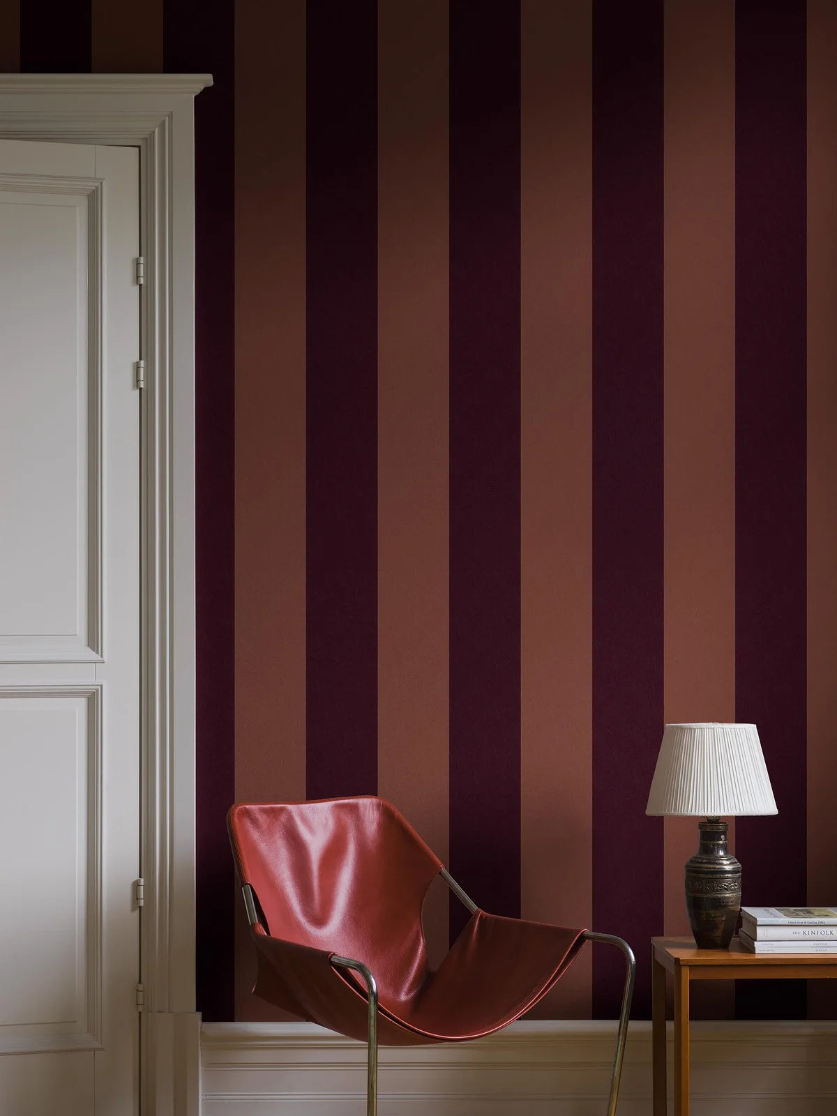 Bjärö Stripe is a wide-striped wallpaper full of character. Bold, extra-wide block stripes presented here in a rich and elegant colorway, where muted brick red meets deep Bordeaux.