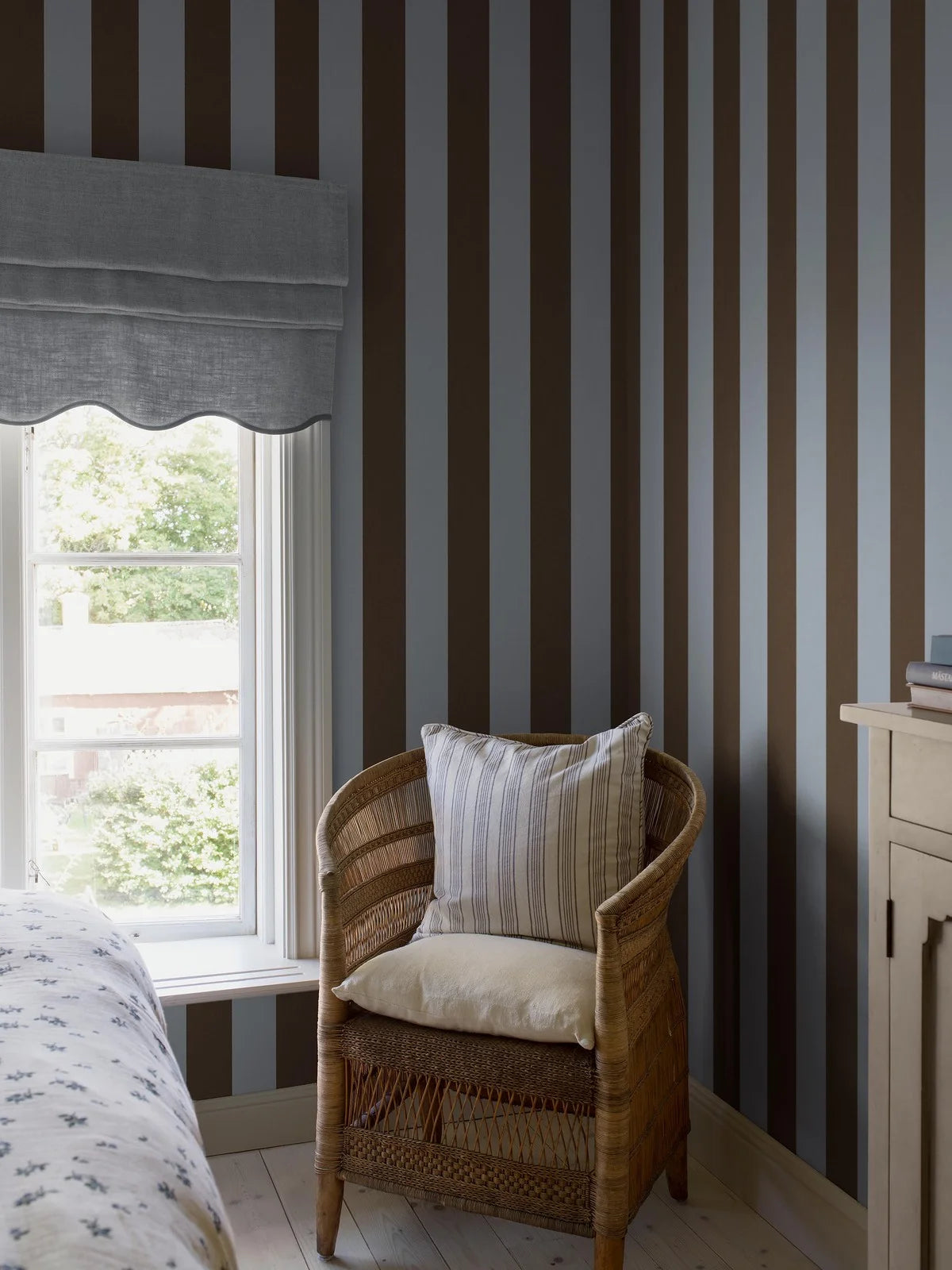 The wide-striped Båstad Stripe wallpaper feels modern and perfectly on trend, with its broad block stripes in dove blue and dark brown.