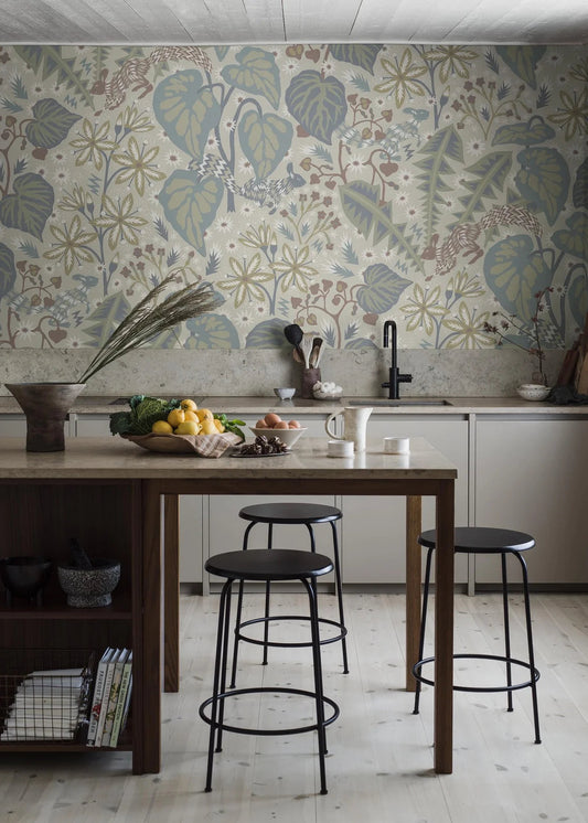 In the large-scale botanical pattern of the mural wallpaper Zingkorre, squirrels dart back and forth among flowers and leaves.