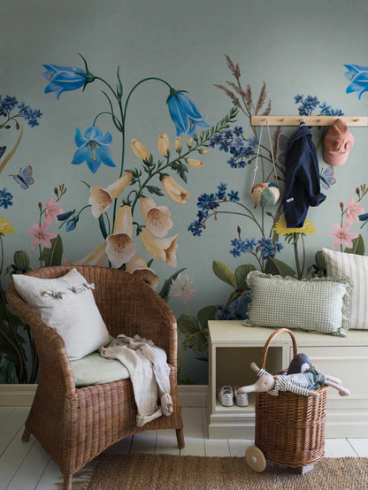 On the Bluebell Magic mural wallpaper, meadow flowers — bluebells, clover, dandelions, and forget-me-nots — stretch gracefully toward the ceiling
