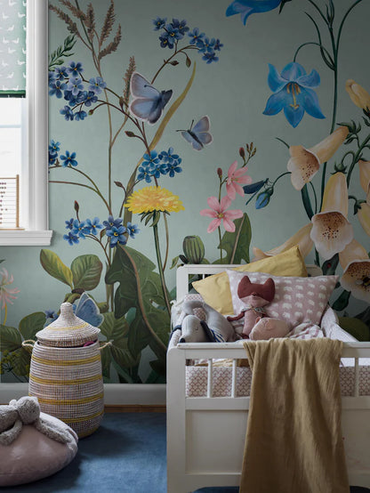 On the Bluebell Magic mural wallpaper, meadow flowers — bluebells, clover, dandelions, and forget-me-nots — stretch gracefully toward the ceiling