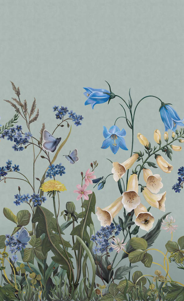 On the Bluebell Magic mural wallpaper, meadow flowers — bluebells, clover, dandelions, and forget-me-nots — stretch gracefully toward the ceiling