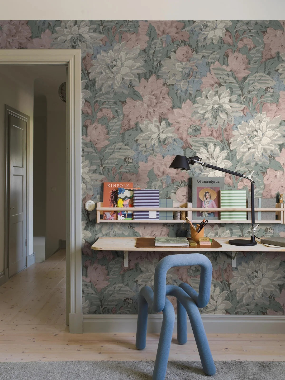 Here, Delilah Grand Wallpaper murals lush dahlia design appears in a soft pastel palette: flowers in muted shades of pink, blue, grey and white set against light blue-green foliage.