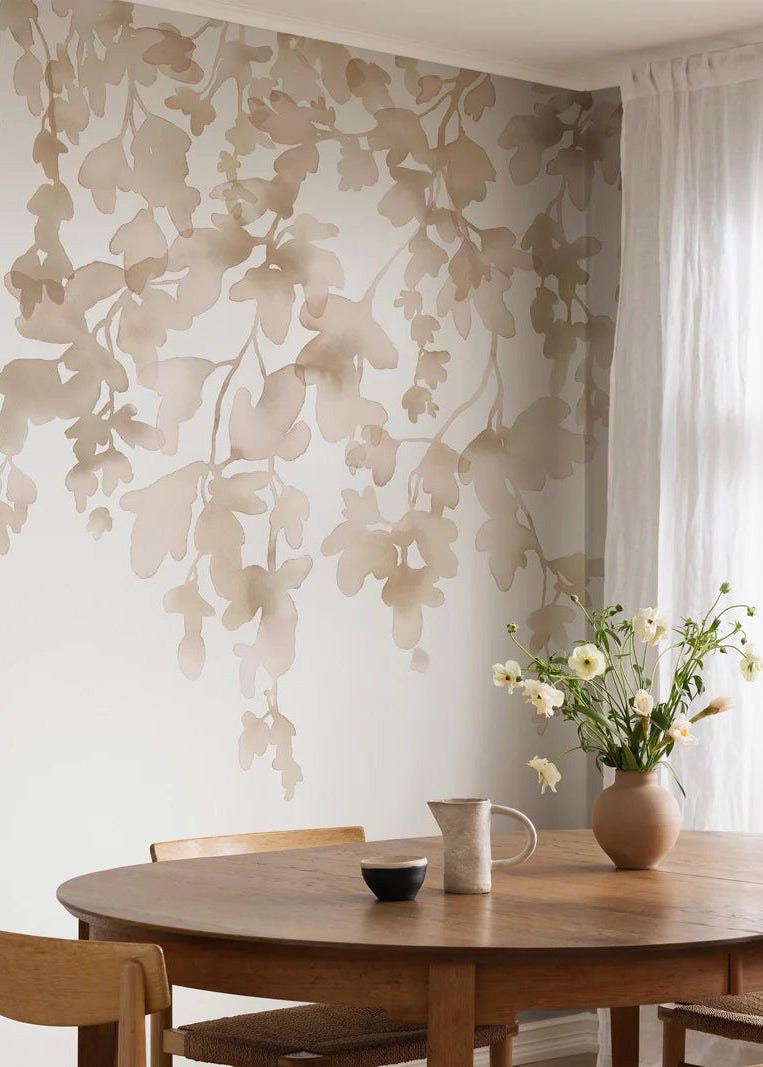 The Dawn Forest wallpaper mural is adorned with delicate, hanging foliage hand-painted in watercolor