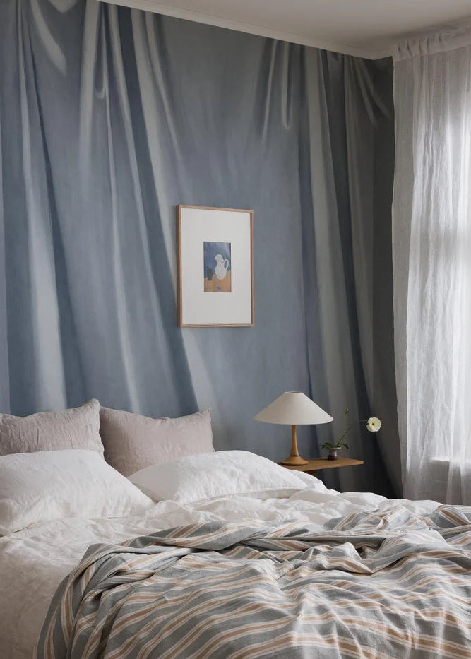 The painterly wallpaper mural Drape captures the feel of softly draping fabric, hand-painted with a canvas texture and artistic brushstrokes.