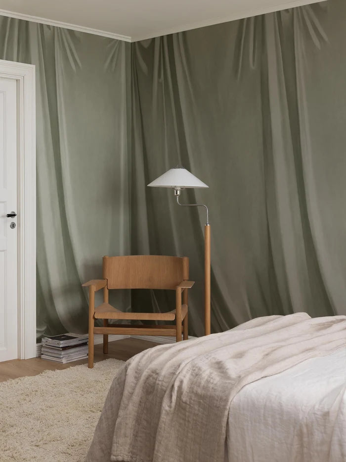 Drape is a hand-painted trompe-l'œil wallpaper mural where soft drapery creates a textile-like, cosy feel on the wall.