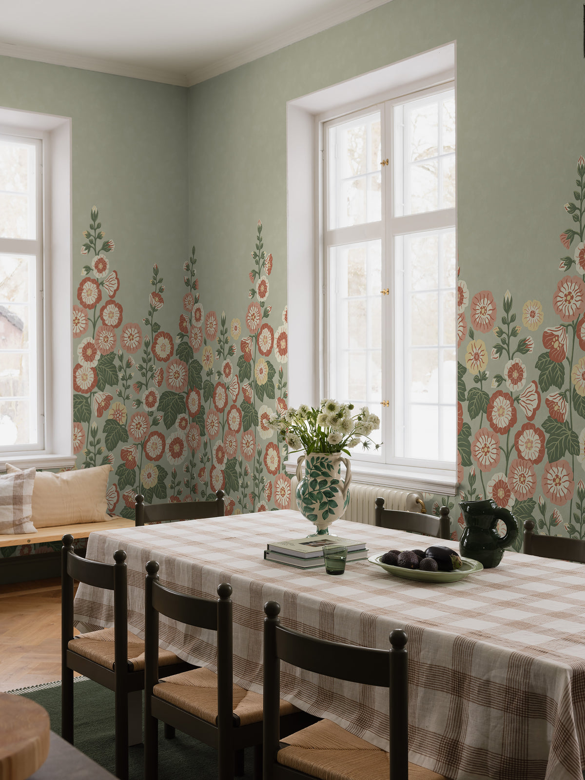 Happy Hollyhocks Grand is a vibrant floral wallpaper where lush hollyhocks grow all the way up to the ceiling.