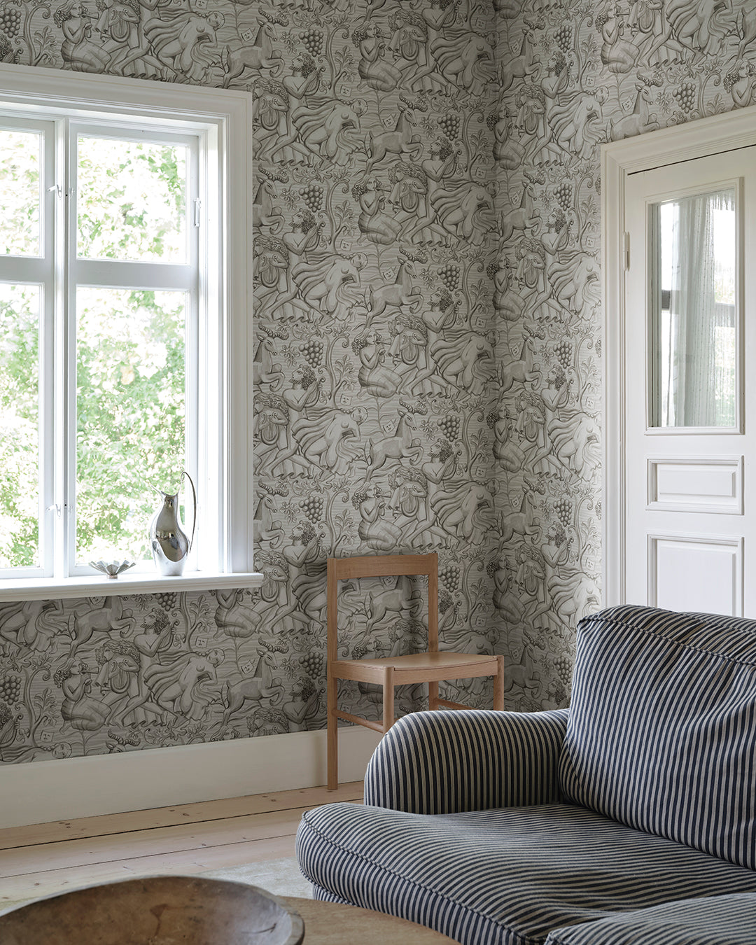 Carl Milles and Anna Petrus's imprint on design history was the source of inspiration for this elegant wallpaper mural. In graphite, Baccus evokes a sense of timeless beauty.