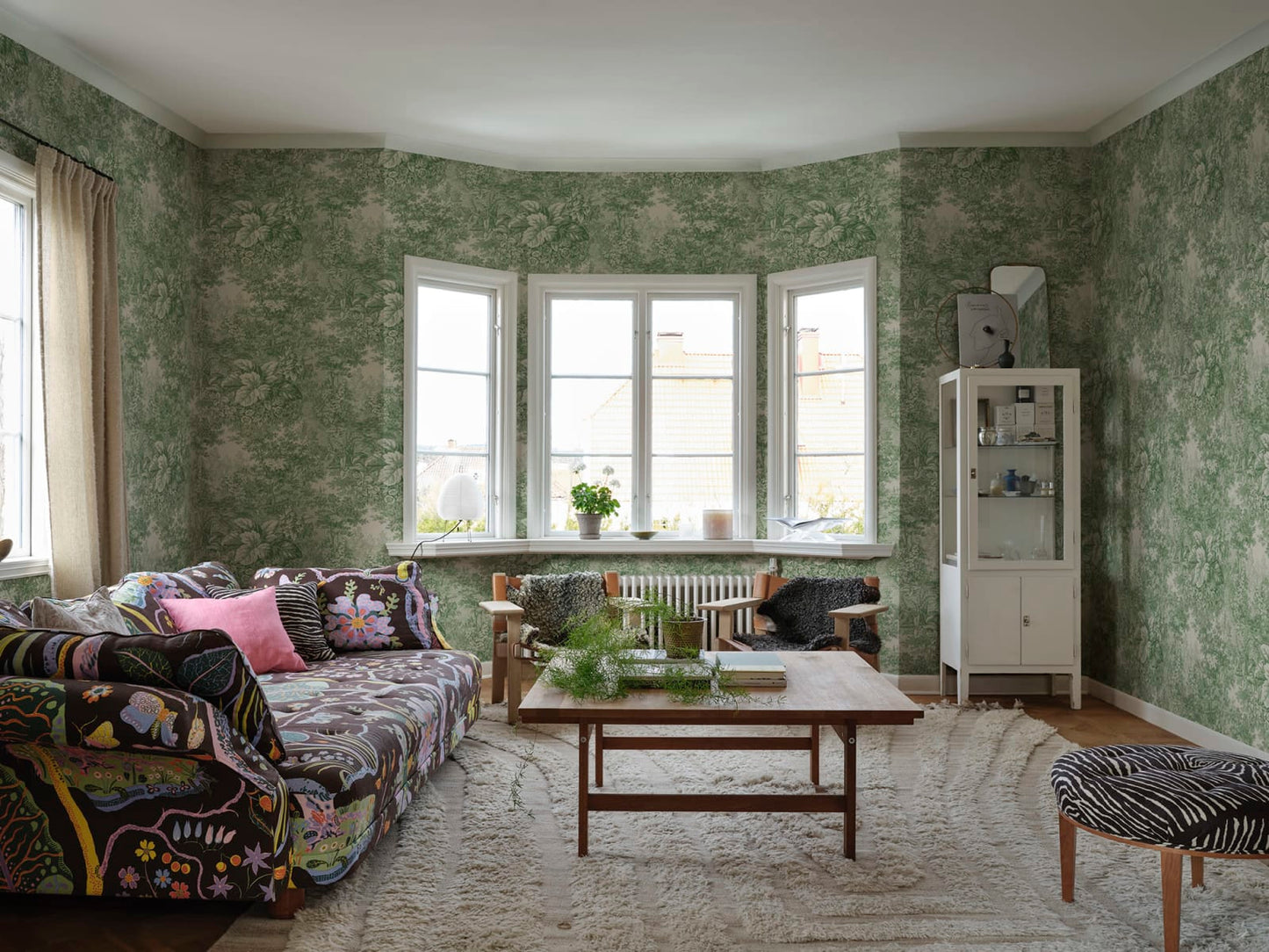 Based on a textile print from 19th century France featuring lush forest clearings that lay the wallpaper like an embracing blanket over the walls.