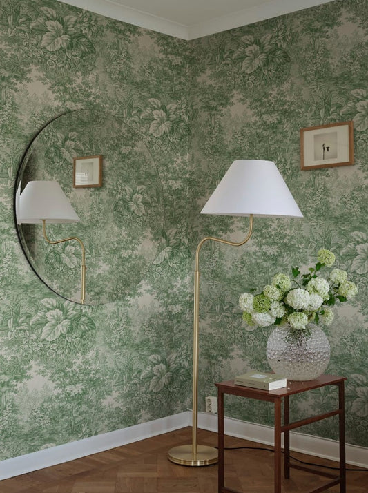 Based on a textile print from 19th century France featuring lush forest clearings that lay the wallpaper like an embracing blanket over the walls.