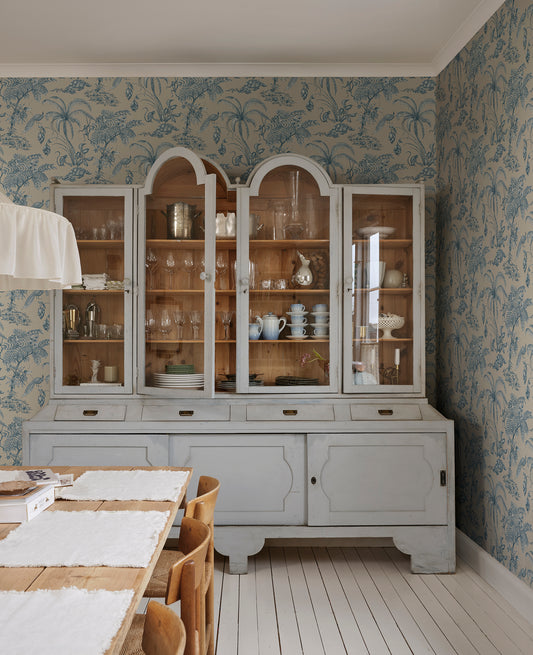 Moa, Indigo Blue wallpaper features a soft beige background with intricate botanical illustrations in indigo blue.