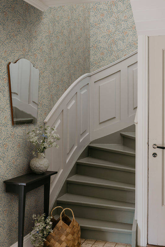 A harmonious surface-printed wallpaper pattern featuring intricate rowan berry branches creates a cozy and welcoming atmosphere with its stylized and enveloping design.