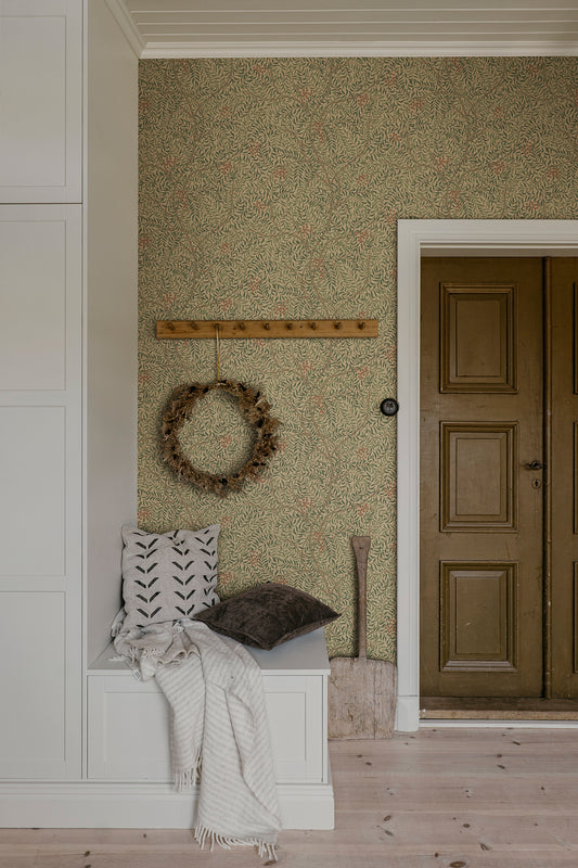A harmonious surface-printed wallpaper pattern featuring intricate rowan berry branches creates a cozy and welcoming atmosphere with its stylized and enveloping design.