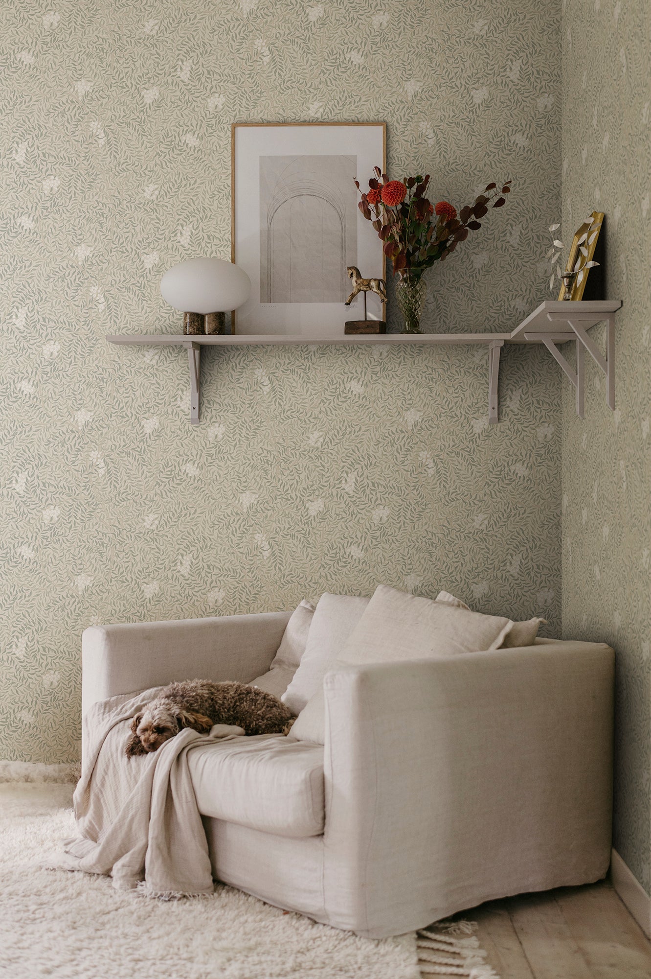 A harmonious surface-printed wallpaper pattern featuring intricate rowan berry branches creates a cozy and welcoming atmosphere with its stylized and enveloping design.