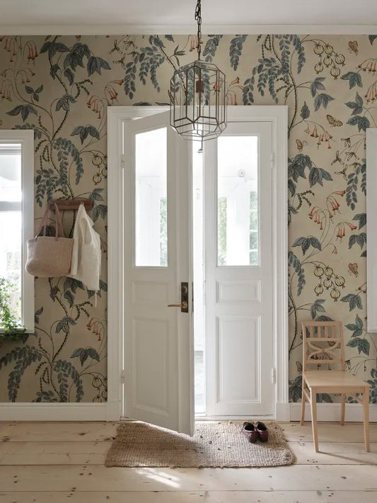 Ottilia, Misty Blue wallpaper has a warm beige background with deep blue and muted red florals.