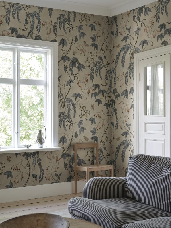 Ottilia, Misty Blue wallpaper has a warm beige background with deep blue and muted red florals.