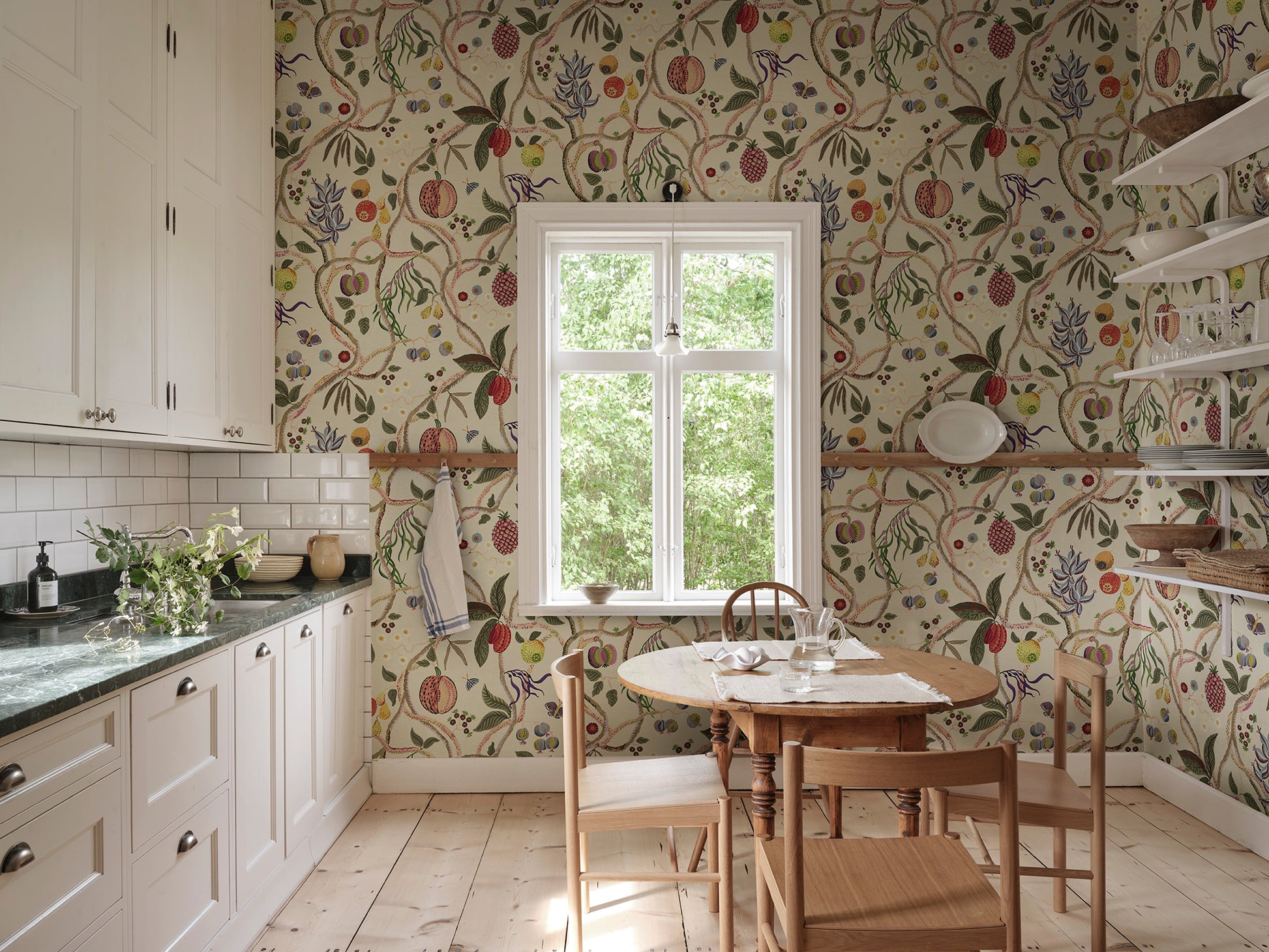 A wallpaper with a playfully hand-painted fantasy tree inspired by plants from Plantae Selectae, adorned with intertwining decorative fruits.