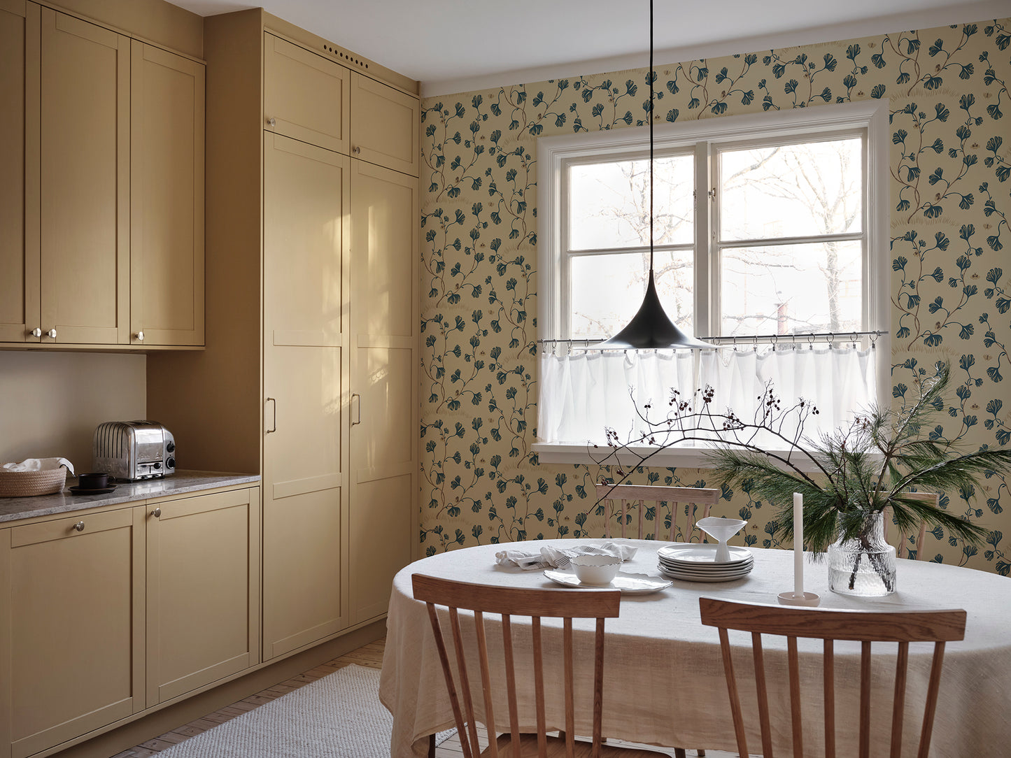 Discover the timeless elegance of the Ebba wallpaper featuring stylized ginkgo leaves and butterflies in a soothing blue palette.