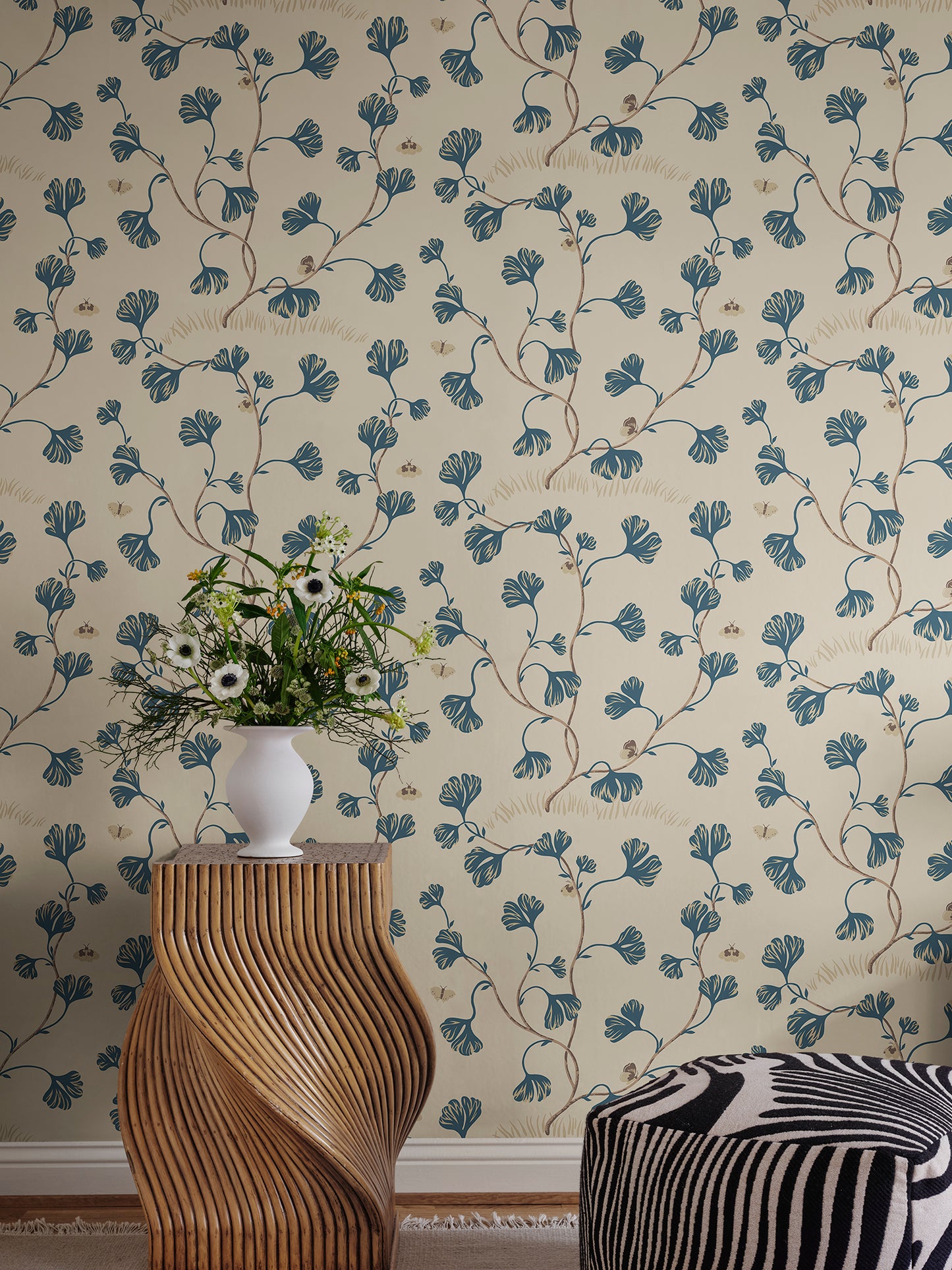 Discover the timeless elegance of the Ebba wallpaper featuring stylized ginkgo leaves and butterflies in a soothing blue palette.