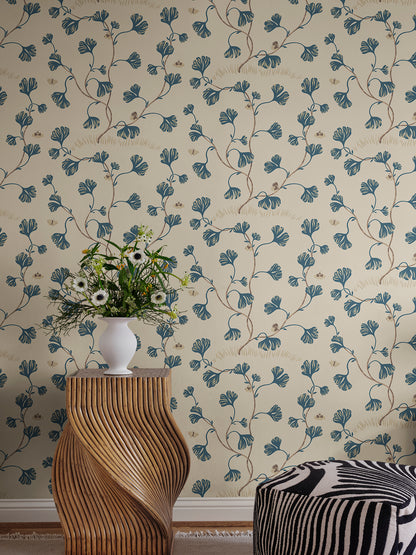 Discover the timeless elegance of the Ebba wallpaper featuring stylized ginkgo leaves and butterflies in a soothing blue palette.