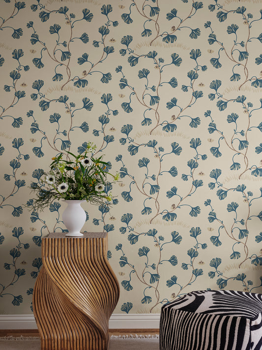 Discover the timeless elegance of the Ebba wallpaper featuring stylized ginkgo leaves and butterflies in a soothing blue palette.