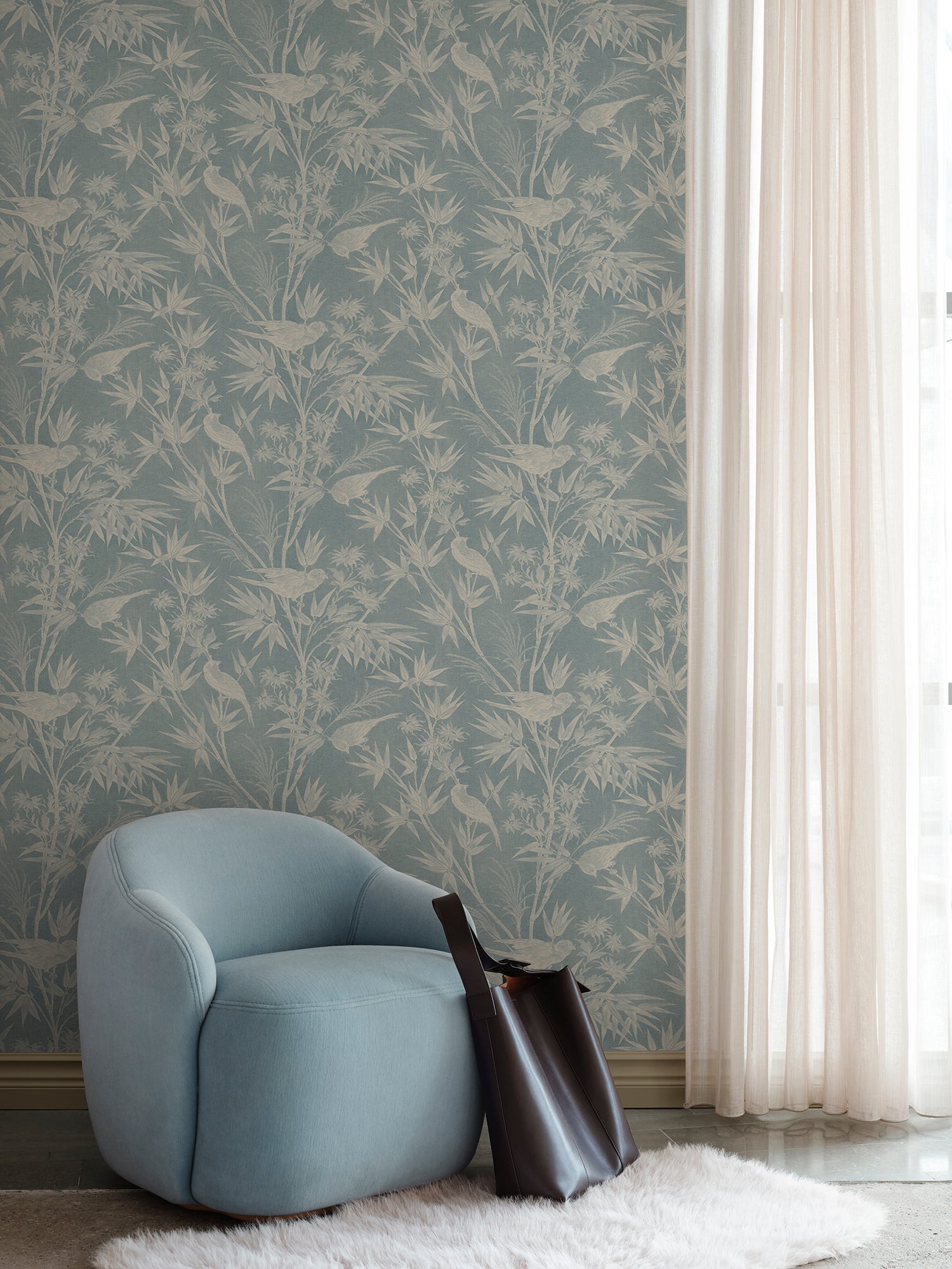 Celeste Misty Blue wallpaper offers a classic toile feel with a soft textile appearance.