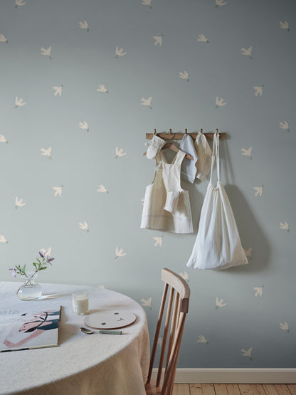 Let tranquility float into your space with the Frida light blue wallpaper, where graceful doves carry peaceful vibes across your walls.