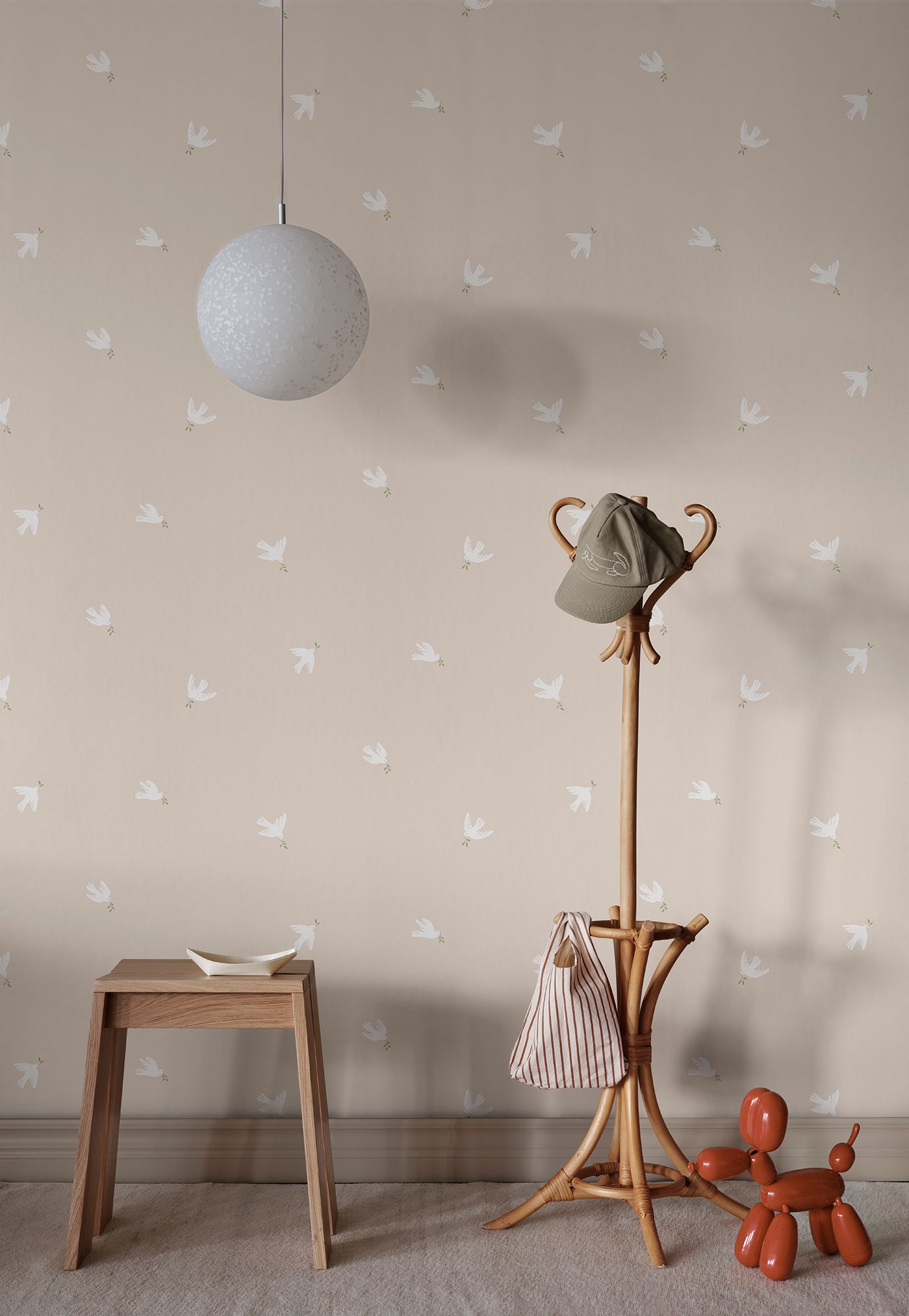 Radiating serenity and grace, the Frida wallpaper features stylized doves gliding through a sandstone sky. 