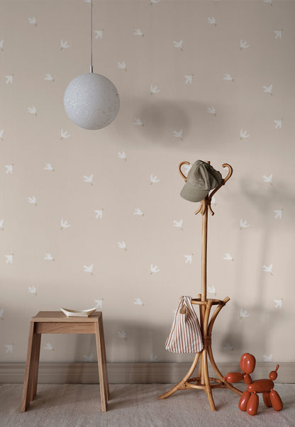  Radiating serenity and grace, the Frida wallpaper features stylized doves gliding through a sandstone sky. 