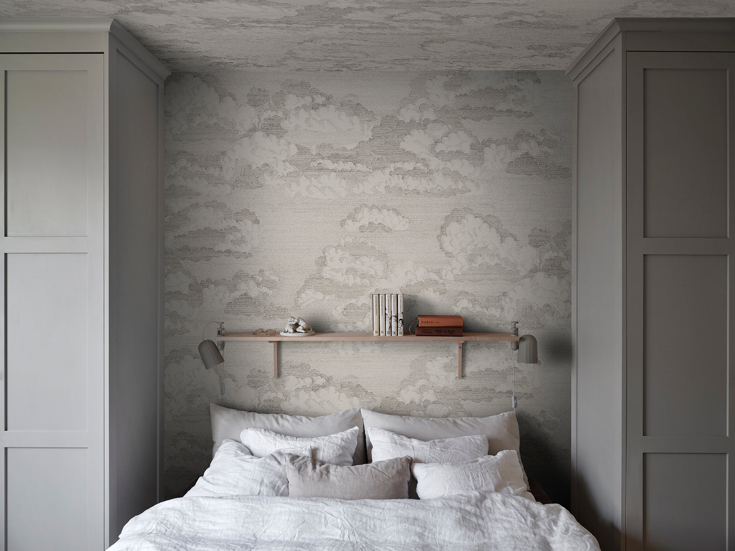 Experience the quiet elegance of the Bonnie wallpaper in graphite. This design captures a dreamy sky view with scattered clouds that evoke classic etchings